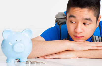 Teen with piggy bank and money
